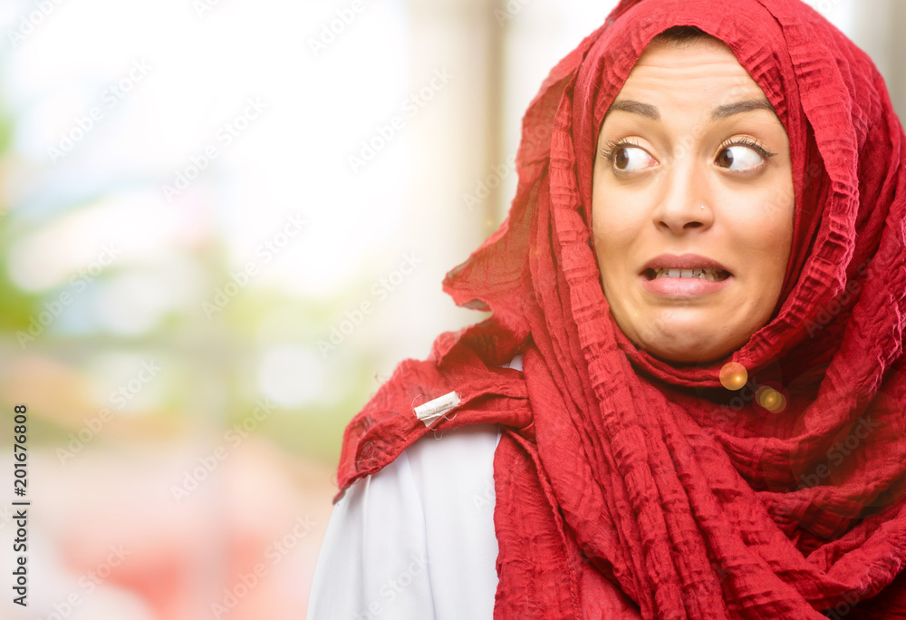 Young arab woman wearing hijab confident and happy with a big natural smile laughing Young arab woman wearing hijab confident and happy with a big natural smile laughing