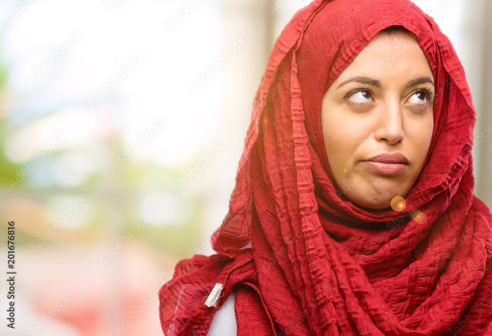 Young arab woman wearing hijab making funny face fooling Young arab woman wearing hijab making funny face fooling