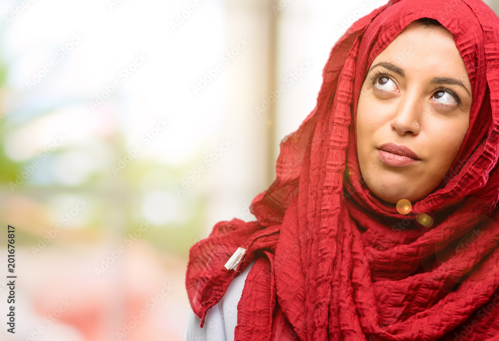 Young arab woman wearing hijab making funny face fooling Young arab woman wearing hijab making funny face fooling