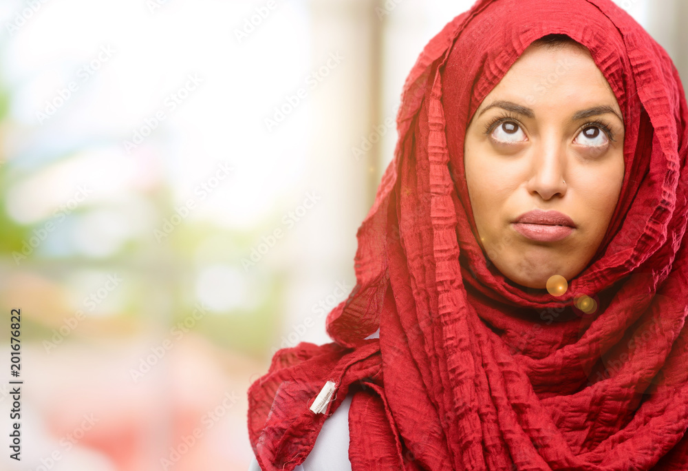 Young arab woman wearing hijab making funny face fooling Young arab woman wearing hijab making funny face fooling
