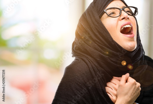 Young arab woman wearing hijab happy and excited celebrating victory expressing big success, power, energy and positive emotions. Celebrates new job joyful