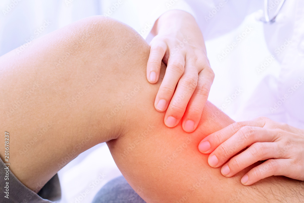man lying with leg pain being massaged for pain relief. Chiropractic, osteopathy, Physiotherapy. man lying with leg pain being massaged for pain relief. Chiropractic, osteopathy, Physiotherapy.