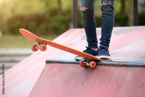 Skateboarder sakteboarding on skatepark ramp