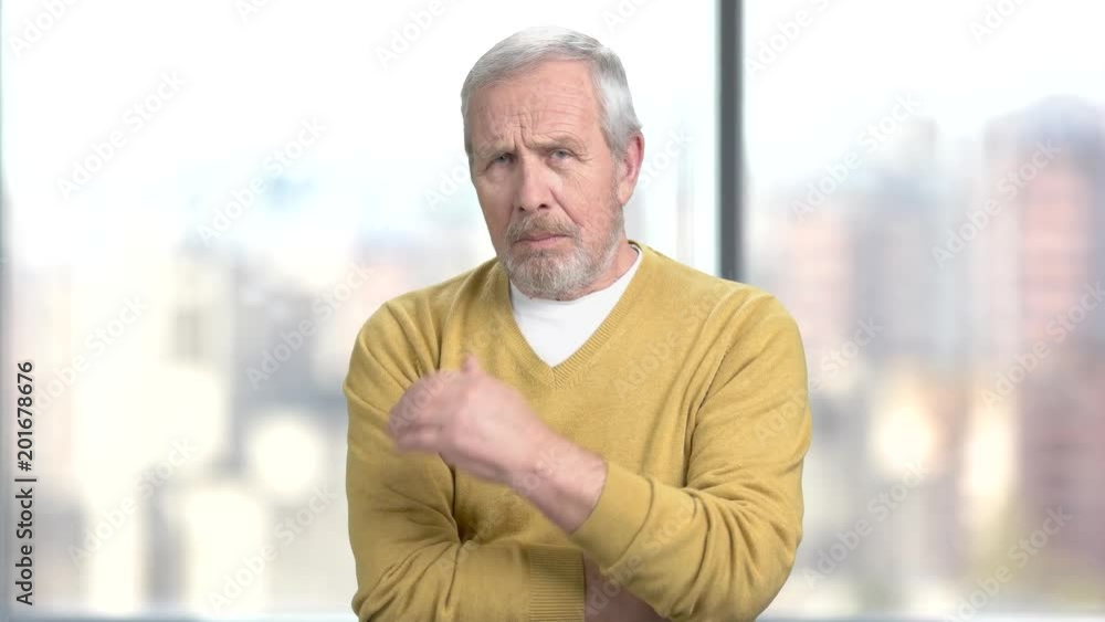 Unhappy man touching his temple. Stressed tired senior man having a bad headache on blurred background. How to diagnose high blood pressure? Unhappy man touching his temple. Stressed tired senior man having a bad headache on blurred background. How to diagnose high blood pressure?