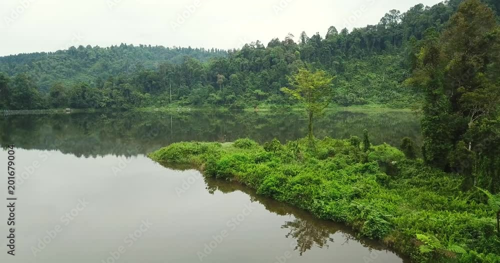 Beautiful aerial landscape of Situ Gunung forest lake with green trees on the morning at Sukabumi, West Java, Indonesia. Shot in 4k resolution Beautiful aerial landscape of Situ Gunung forest lake with green trees on the morning at Sukabumi, West Java, Indonesia. Shot in 4k resolution