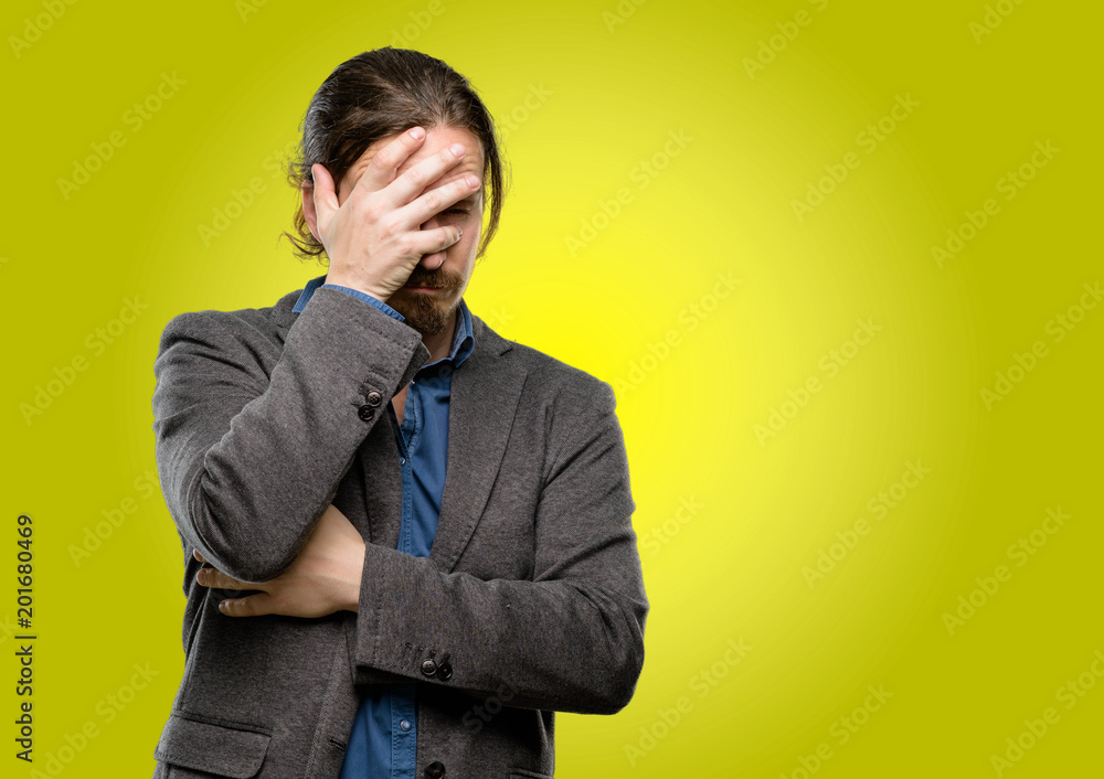 Handsome young man stressful keeping hands on head, tired and frustrated Handsome young man stressful keeping hands on head, tired and frustrated