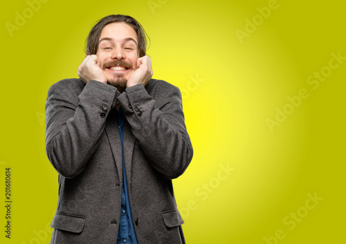 Handsome young man confident and happy with a big natural smile laughing