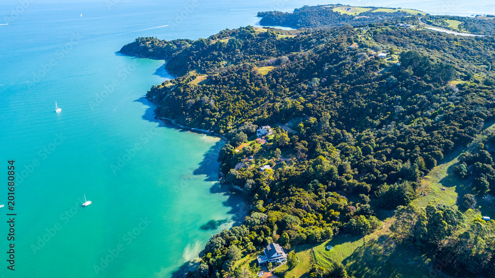 Aerial view on a beautiful harbour surrounding rocky peninsula with residential houses. Waiheke Island, Auckland, New Zealand