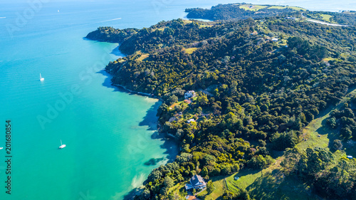 Aerial view on a beautiful harbour surrounding rocky peninsula with residential houses. Waiheke Island, Auckland, New Zealand © Dmitri