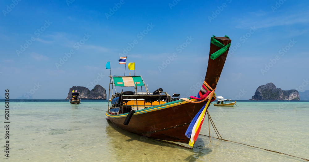 traditional thai boat in the sea and blue sky traditional thai boat in the sea and blue sky
