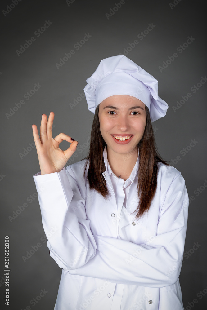 Beautiful Turkish smiling young female chef with confident expression Beautiful Turkish smiling young female chef with confident expression