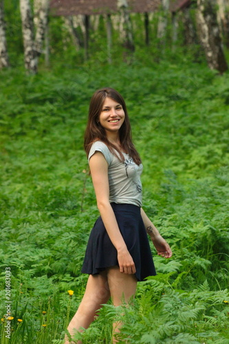 Beautiful smiling girl is walking in the woods