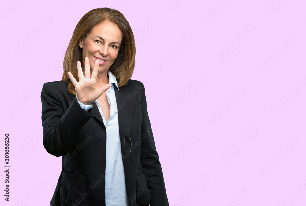 Middle age business woman raising his finger, is the number five Middle age business woman raising his finger, is the number five