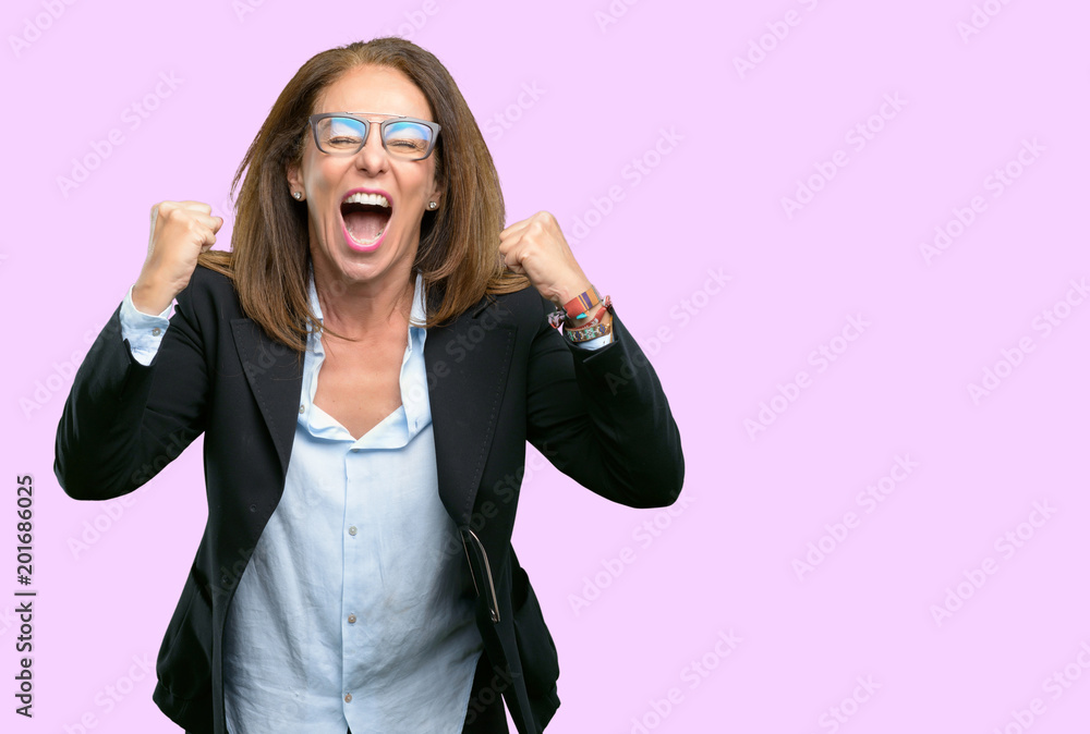 Middle age business woman happy and excited celebrating victory expressing big success, power, energy and positive emotions. Celebrates new job joyful Middle age business woman happy and excited celebrating victory expressing big success, power, energy and positive emotions. Celebrates new job joyful