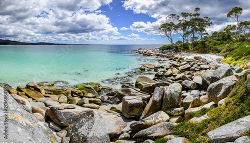 Beautiful sunny summer coast view from Bay Of Fires to blue Tasman Sea with crystal clear water surrounded by red orange colorful shore rocks and white sandy beach, Binalong Bay, Tasmania, Australia © Thomas Jastram