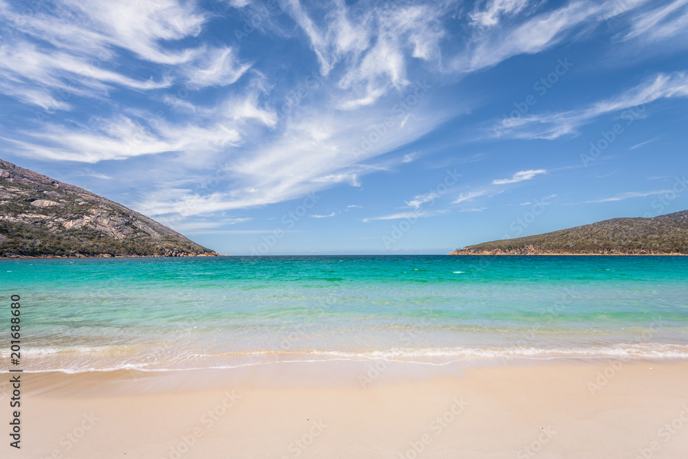 Relaxing amazing view to stunning sandy beach blue turqouise water enjoy swiming warm sunny day with blue sky after hiking on top mountains, Freycinet National Park, Wineglass Bay, Tasmania, Australia
