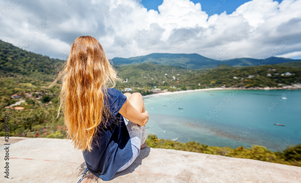 Young beautiful woman  with long blonde flying hair, travel concept, sea view point