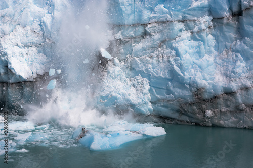 Blue ice falling into the lake at Perito Moreno Glacier, one of the most important tourist attractions in the Patagonia, located in the Los Glaciares National Park in southwest Santa Cruz, Argentina