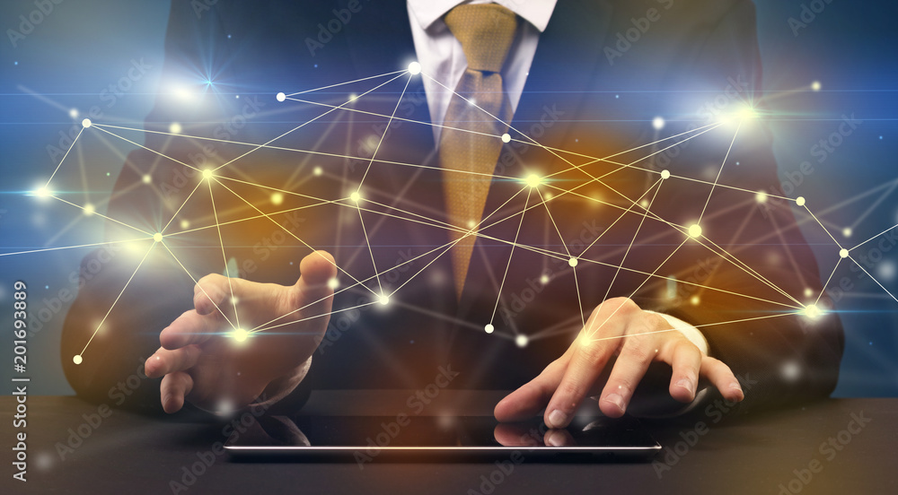 Businessman in suit typing with connection graphics around Businessman in suit typing with connection graphics around