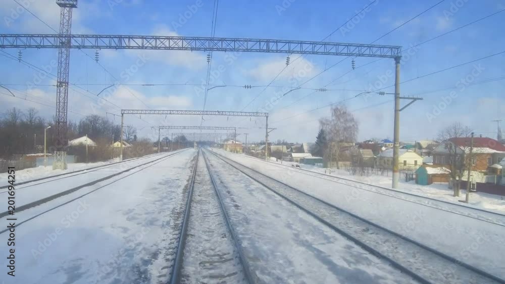 4K Point of view from the train locomotive. The train passes the railway station without stopping. 4K Point of view from the train locomotive. The train passes the railway station without stopping.