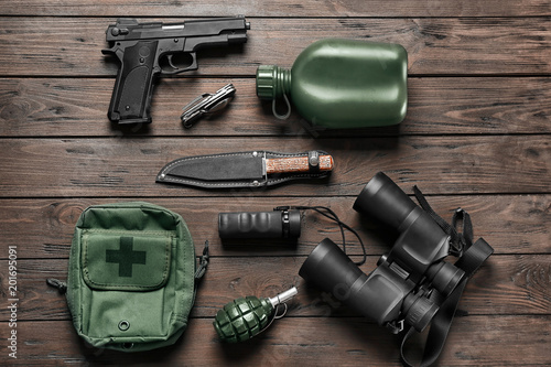 Set of military outfit on wooden background, flat lay photo