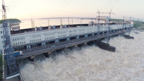 Top view of the hydroelectric power station on the river. Clip. Cheap electricity at the modern hydroelectric power station photo