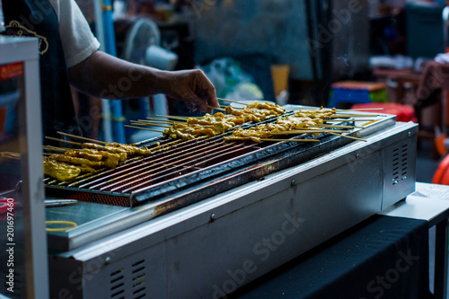 HaTraditional yakitori chicken stand in asian at street food vendor market, grilled satay in Thailand, Asian food stylend of cooking satay grill.