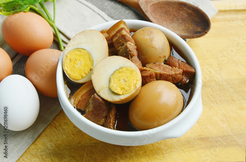 Thai Egg Menu.
Eggs Stewed or Thai name is khai phalo muu saam chan on wooden background photo