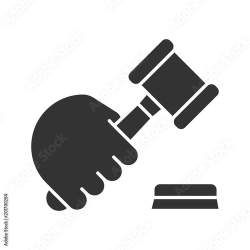 Hand holding gavel glyph icon