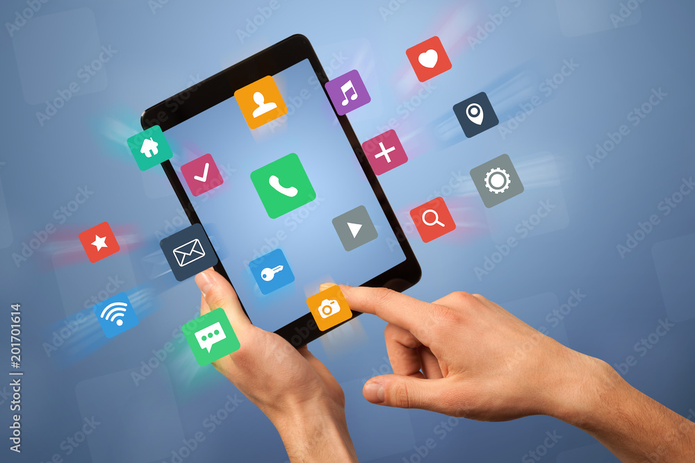 Female fingers touching tablet with colorful applications Female fingers touching tablet with colorful applications