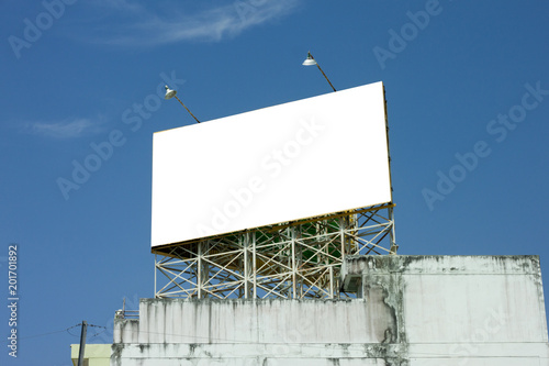 Board present various ads on building with blue sky for background