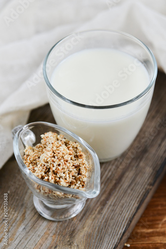 sesame milk sesame seed in a glass on wooden background, concept of healthy eating, organic food, gluten-free and aslacton vegetable milk.