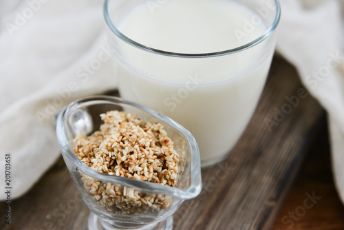 sesame milk sesame seed in a glass on wooden background, concept of healthy eating, organic food, gluten-free and aslacton vegetable milk.