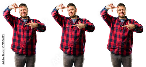 Young man confident and happy showing hands to camera, composing and framing gesture isolated over white background, collage composition