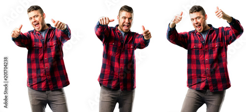Young man stand happy and positive with thumbs up approving with a big smile expressing okay gesture isolated over white background, collage composition