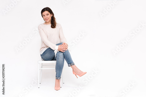 girl sitting on a chair on a white background in different poses