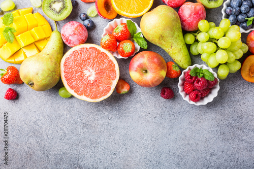 Obraz na plátně Fresh assorted fruits and berries on light gray background