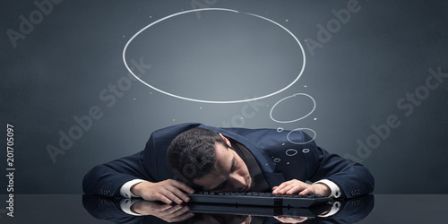 Young businessman sleeping and dreaming at the office
