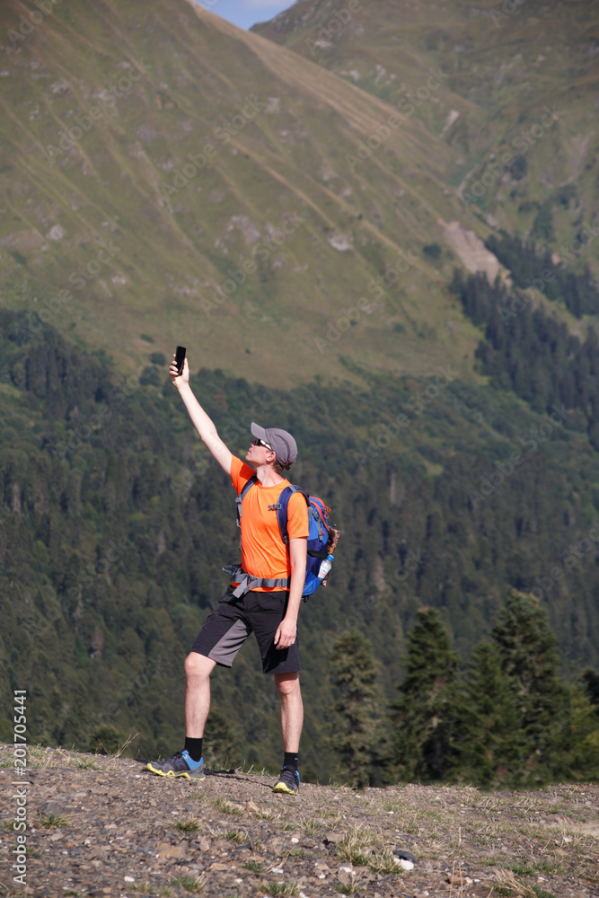 Obraz premium Image of man photographing telephone background of mountain