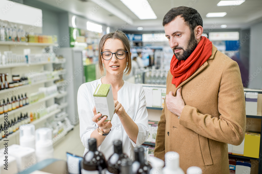 Pharmacist with client in the pharmacy store Pharmacist with client in the pharmacy store