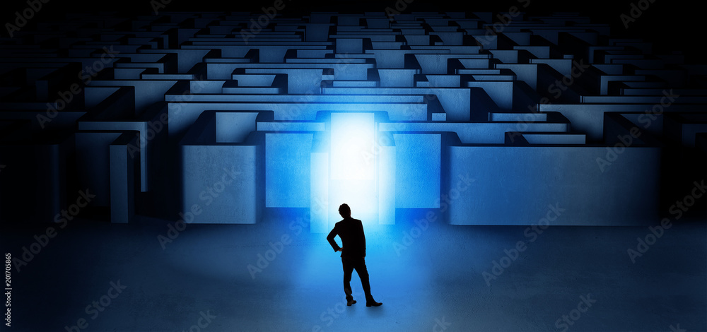 Lost businessman standing at the dark labyrinth with illuminated door
Lost businessman standing at the dark labyrinth with illuminated door