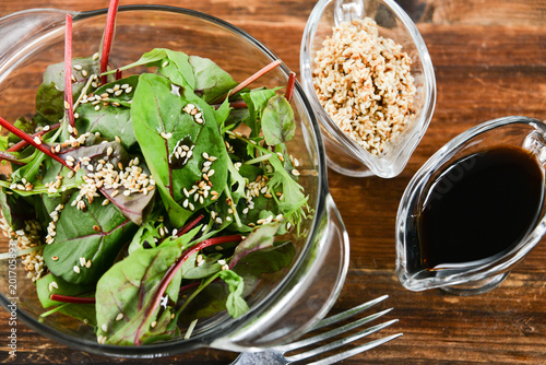 a salad of fresh greens and sesame seeds with soy sauce, Asian national cuisine photo