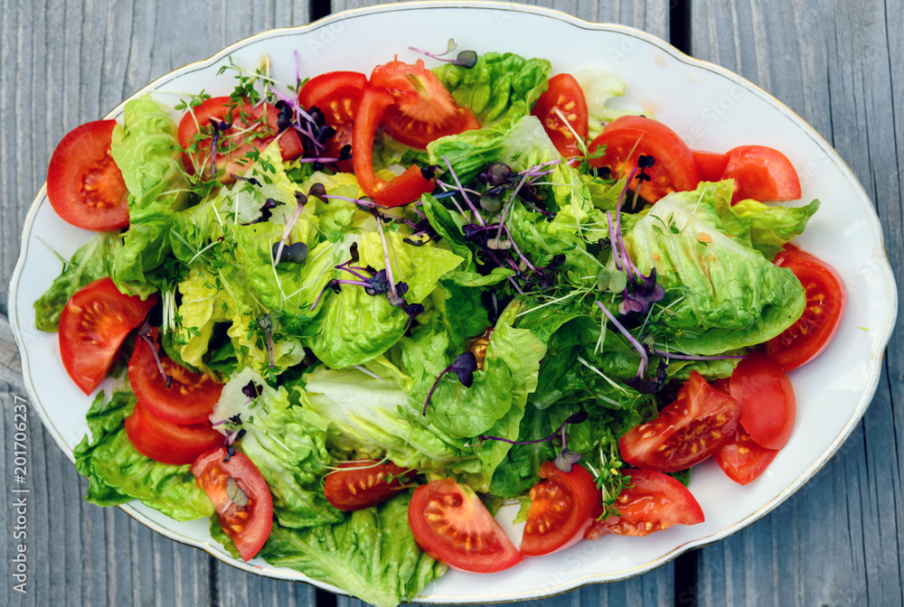 mixed summer salad on wooden ground mixed summer salad on wooden ground