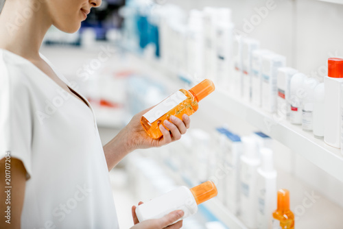 Taking sunscreen lotion at the pharmacy