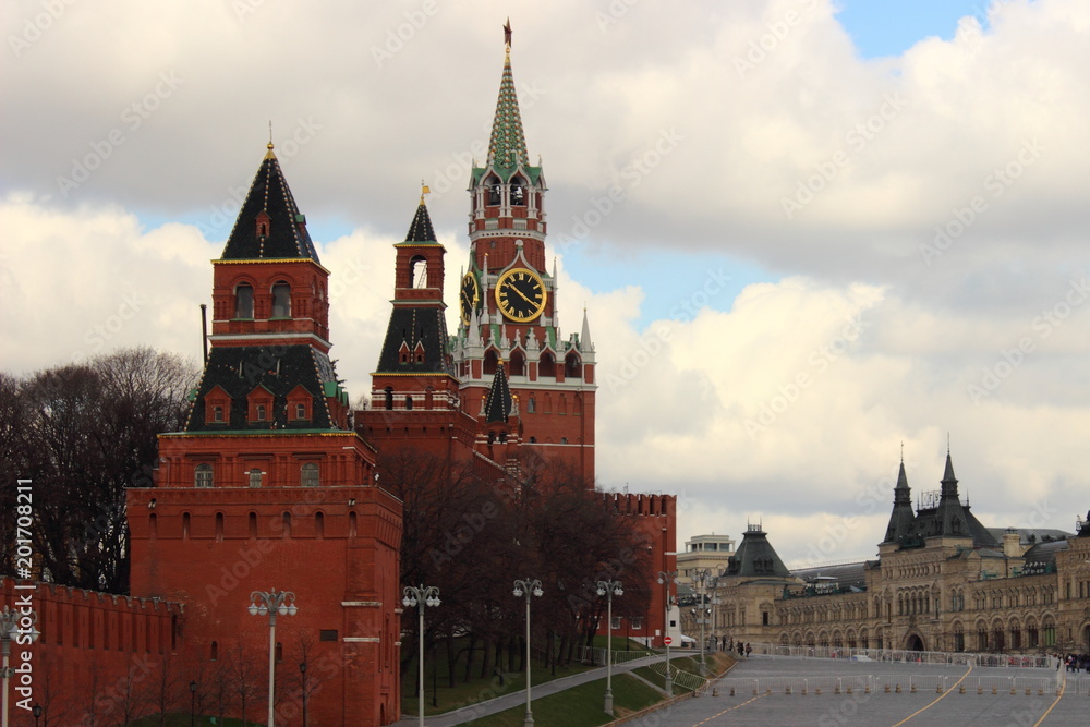 Russia, Moscow, the center – view of the Spasskaya tower, St. Basil's descent, GUM, Kremlin wall and towers of red square in the spring on a background cloudy sky