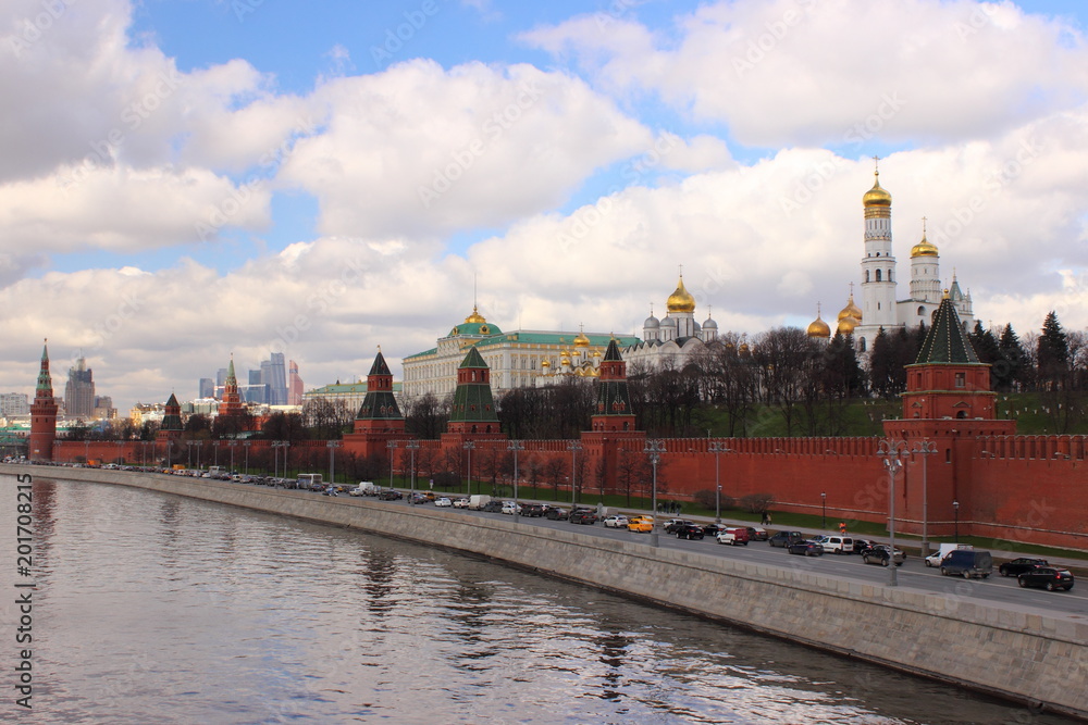 Russia, Moscow, center - view from the Big stone bridge on the Kremlin wall, the Church with Golden domes and towers of red square in the spring against the cloudy sky Russia, Moscow, center - view from the Big stone bridge on the Kremlin wall, the Church with Golden domes and towers of red square in the spring against the cloudy sky