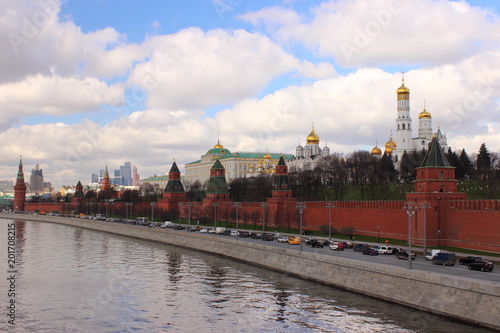 Russia, Moscow, center - view from the Big stone bridge on the Kremlin wall, the Church with Golden domes and towers of red square in the spring against the cloudy sky