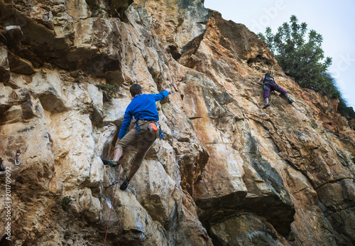 Male Rock climber with rock climbing in the impressive cliff located in the western section of the West Bank (between Jerusalem and Tel Aviv)