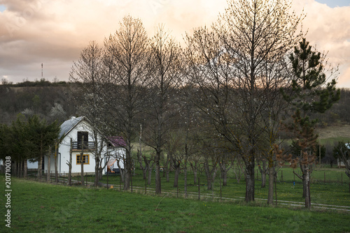 Village house in a field at sunset. Plitvice lakes, Croatia UNESCO world heritage site