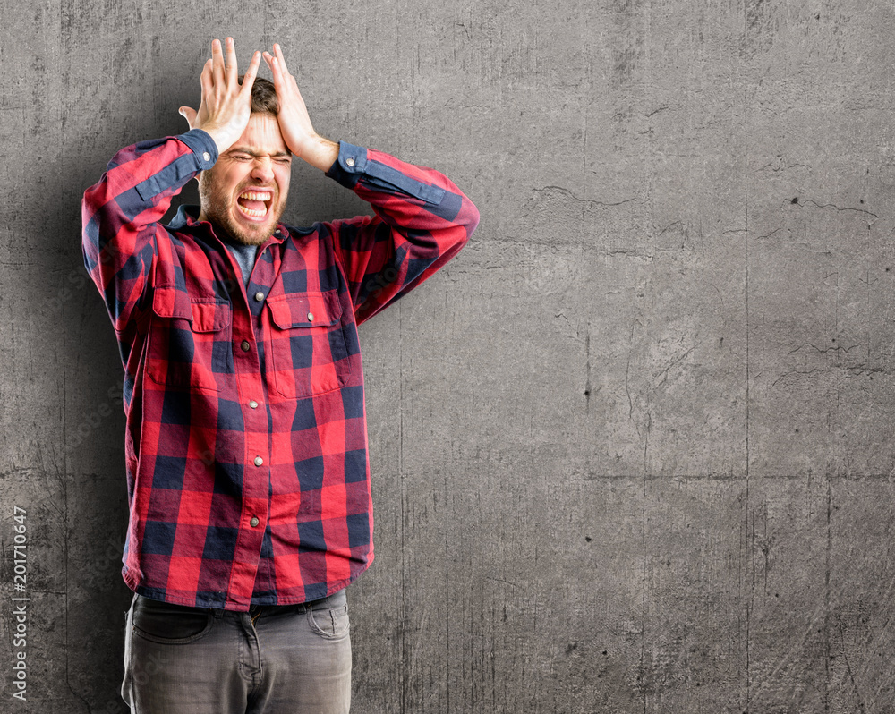 Young handsome man terrified and nervous expressing anxiety and panic gesture, overwhelmed Young handsome man terrified and nervous expressing anxiety and panic gesture, overwhelmed